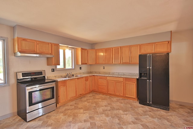 kitchen featuring stainless steel range with electric cooktop, light brown cabinets, under cabinet range hood, and black refrigerator with ice dispenser