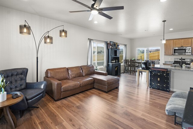 living area featuring recessed lighting, a ceiling fan, and dark wood-style flooring