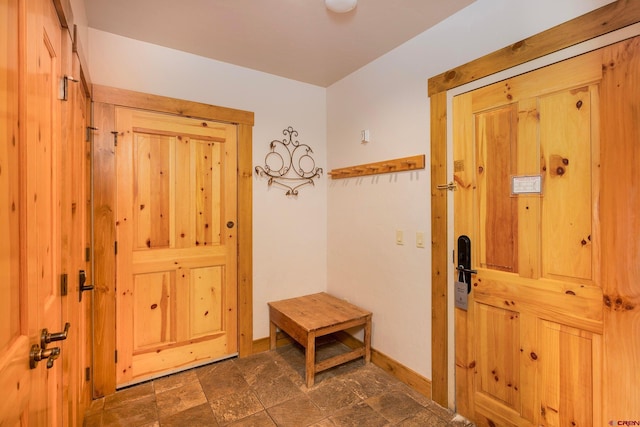 doorway to outside featuring baseboards