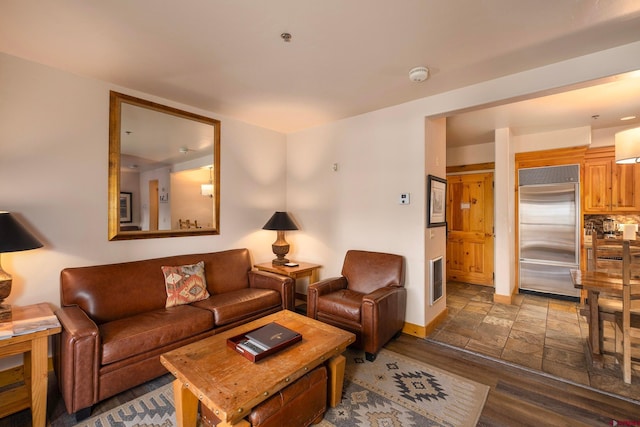 living room with stone finish floor and baseboards