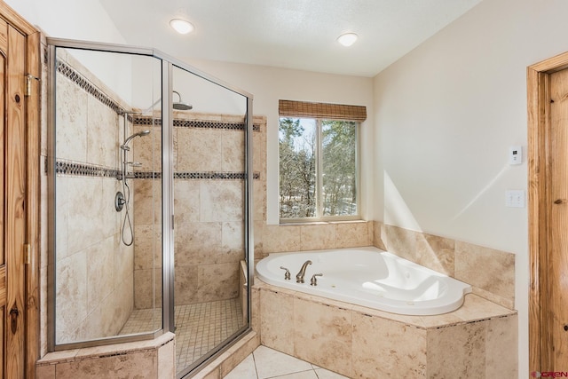 full bath with a bath, tile patterned floors, and a stall shower