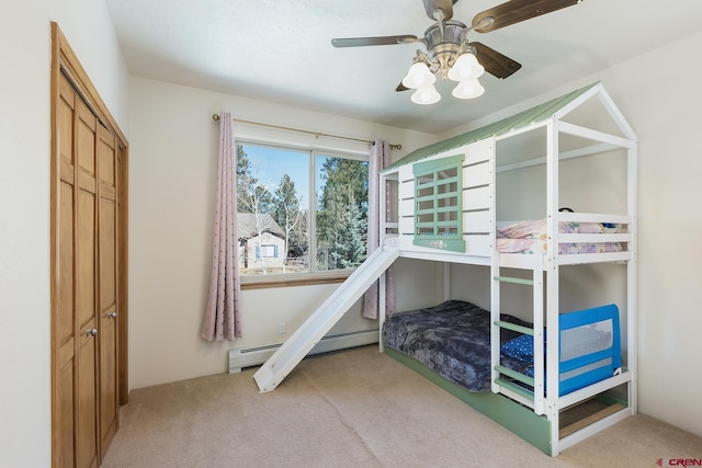 bedroom featuring carpet flooring, a ceiling fan, and a baseboard radiator