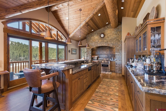 kitchen featuring glass insert cabinets, wood ceiling, brown cabinetry, and light wood-type flooring