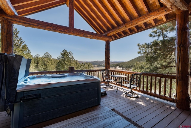 wooden terrace with a mountain view and a hot tub