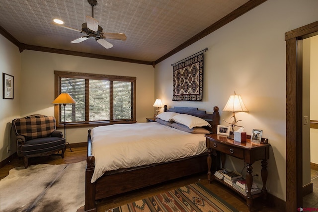 bedroom with baseboards, a ceiling fan, wood finished floors, and crown molding