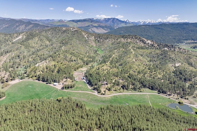 bird's eye view with a forest view and a mountain view