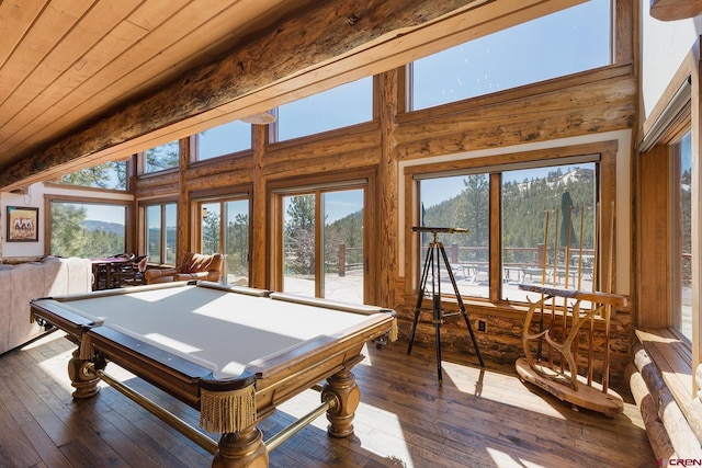 recreation room featuring dark wood finished floors, pool table, wood ceiling, and a towering ceiling