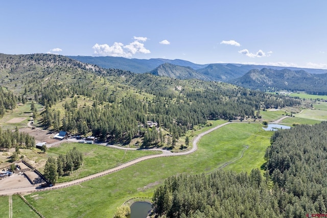 aerial view with a mountain view and a wooded view