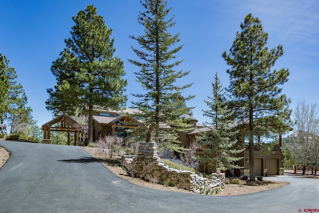 view of side of property featuring an attached garage and driveway