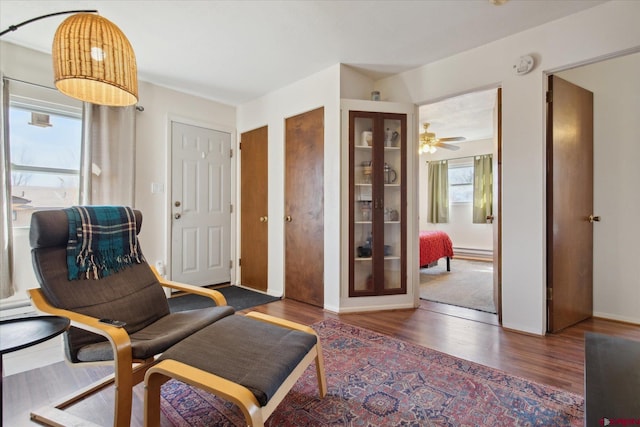 sitting room with wood finished floors and baseboards