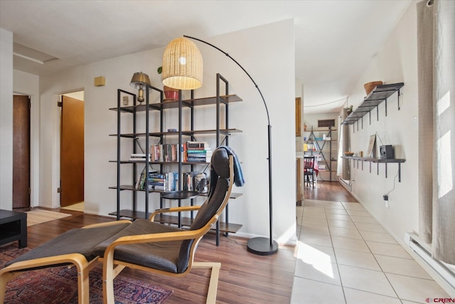 interior space with wood finished floors and baseboard heating