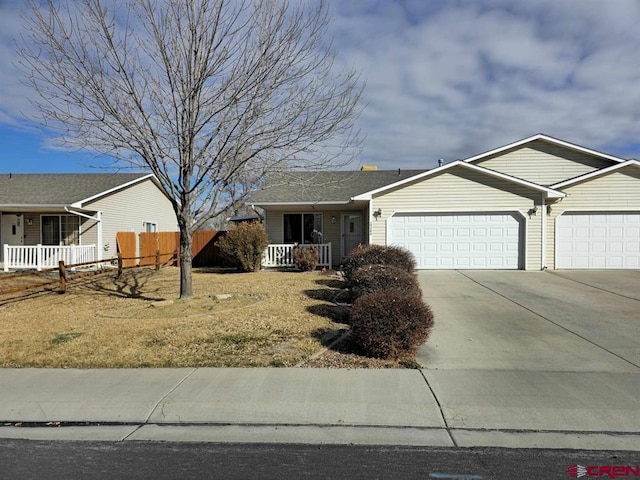 ranch-style home featuring a garage, covered porch, concrete driveway, and fence