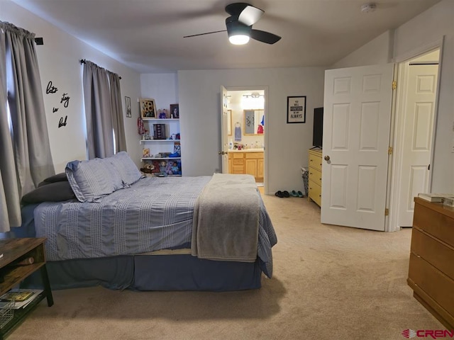 bedroom featuring connected bathroom, light colored carpet, and ceiling fan