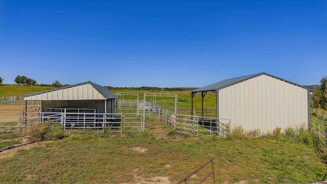 view of outdoor structure with an outbuilding, a rural view, and an exterior structure