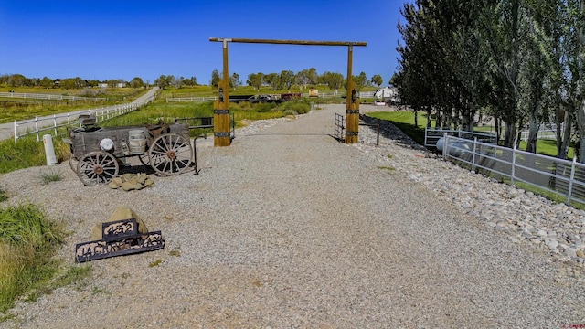 view of home's community featuring a rural view and fence