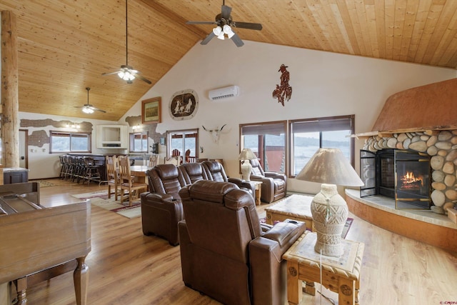 living area with a wall mounted air conditioner, a stone fireplace, wood ceiling, and wood finished floors