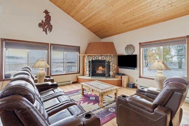 living room featuring high vaulted ceiling, a baseboard heating unit, light wood-style floors, a stone fireplace, and wood ceiling