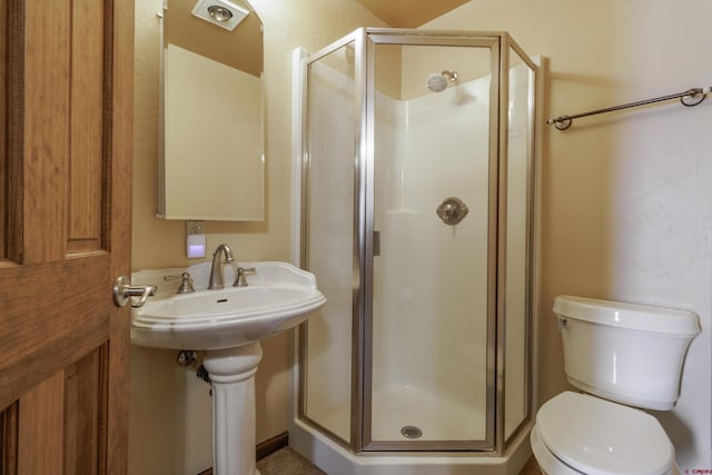 full bath featuring toilet and a shower stall