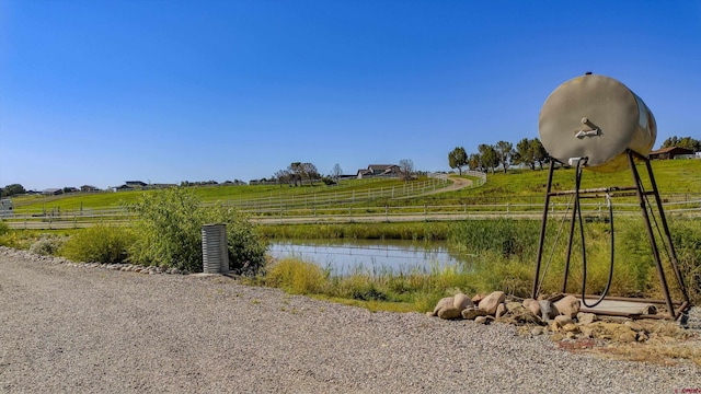 water view with a rural view and fence