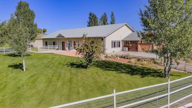 back of house with a yard, a patio, and fence