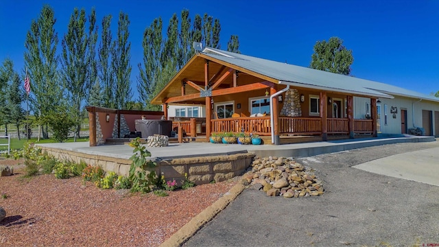 view of front of home with a porch and metal roof