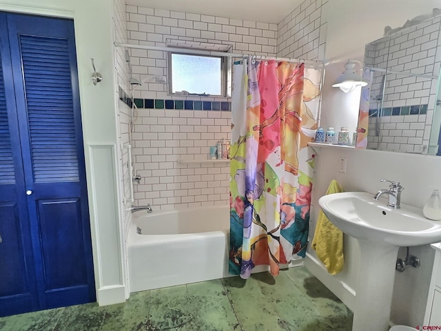 bathroom with tile patterned flooring, shower / bath combination with curtain, and a sink