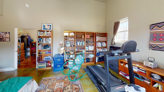 office featuring tile patterned flooring, a high ceiling, and baseboards