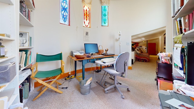 carpeted home office with a high ceiling