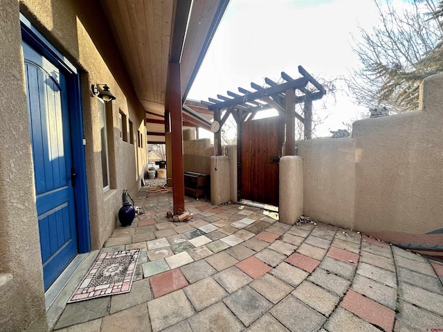 view of patio / terrace with a gate, fence, and a pergola