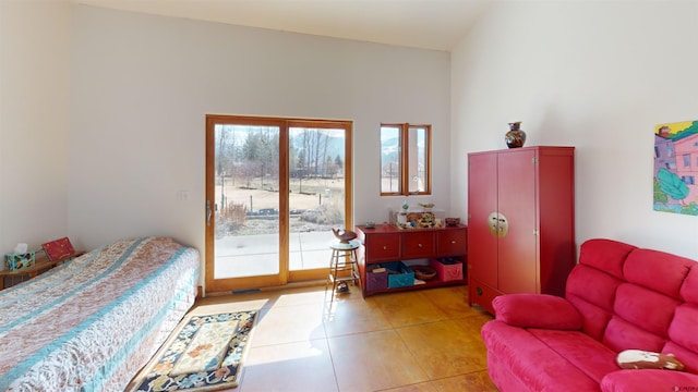 bedroom featuring light tile patterned floors and access to outside