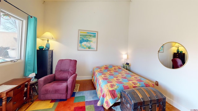 bedroom with multiple windows and baseboards