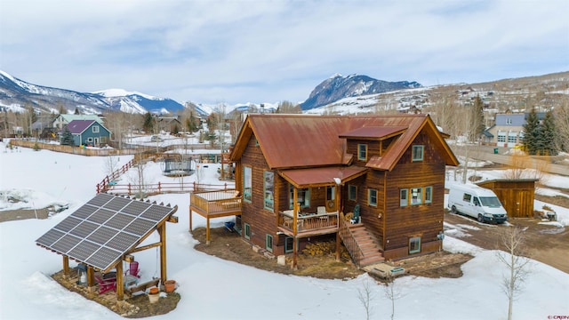 exterior space with stairway, solar panels, and a mountain view