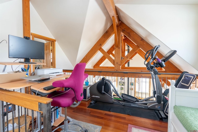 interior space with wood finished floors and vaulted ceiling with beams