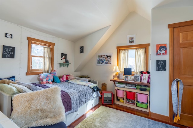 bedroom featuring lofted ceiling and wood finished floors