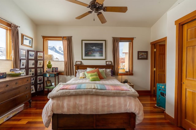 bedroom with baseboards, dark wood-type flooring, and ceiling fan