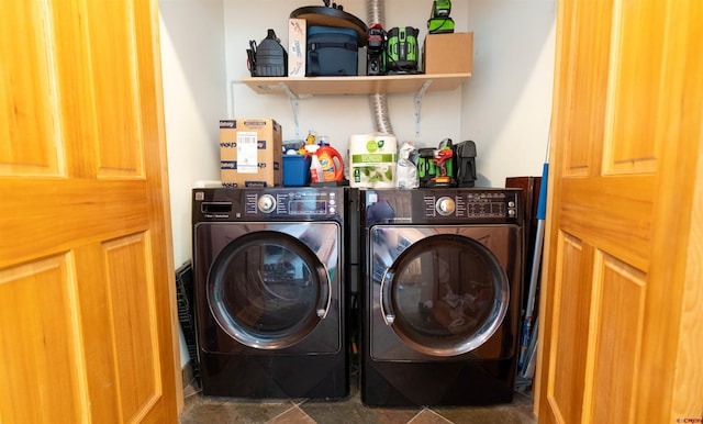 clothes washing area featuring washer and clothes dryer and laundry area