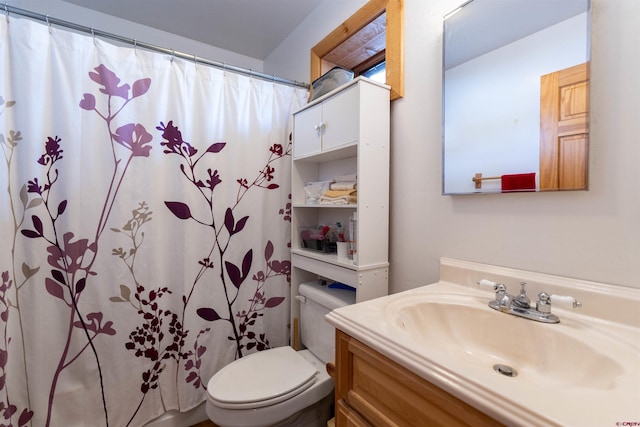 bathroom with vanity, a shower with shower curtain, and toilet