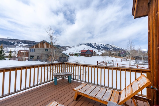 snow covered deck with a mountain view