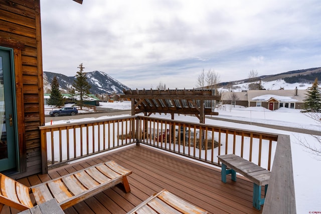 snow covered deck featuring a mountain view