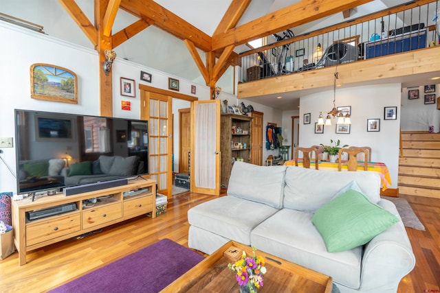 living room featuring a chandelier, beamed ceiling, high vaulted ceiling, and wood finished floors