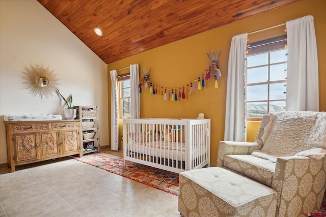 bedroom with vaulted ceiling, wood ceiling, baseboards, and tile patterned floors