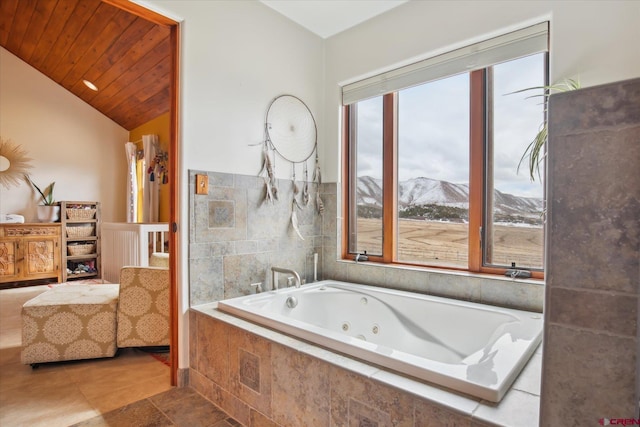 bathroom with a tub with jets, a mountain view, wood ceiling, and lofted ceiling