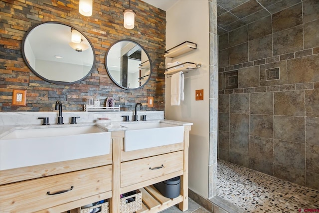 full bath featuring double vanity, walk in shower, and a sink