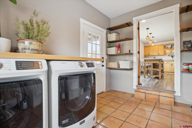 laundry room with light tile patterned flooring, laundry area, and separate washer and dryer