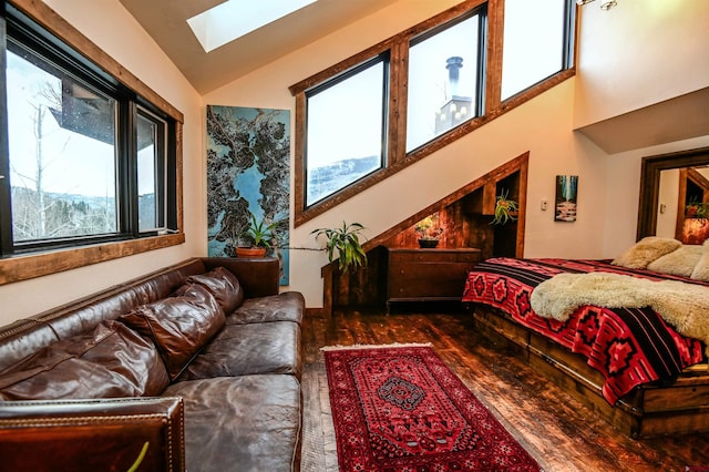 bedroom featuring vaulted ceiling with skylight and wood finished floors