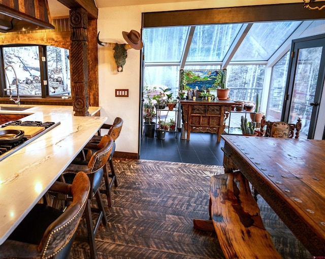 dining space with tile patterned flooring and a sunroom