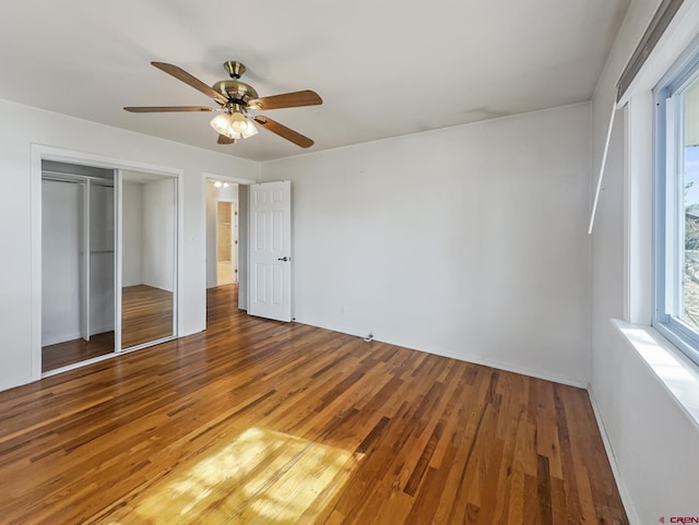 unfurnished bedroom featuring a closet, ceiling fan, and wood finished floors