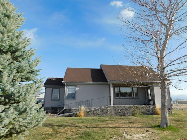 14977 F Rd, Delta, CO 81416 - view of side of home featuring a yard, covered porch, and roof with shingles