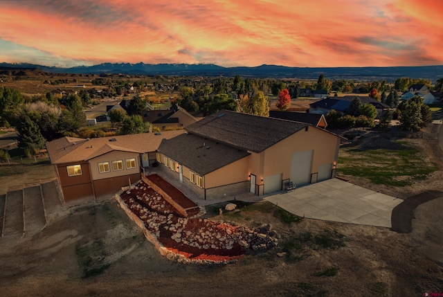 aerial view at dusk with a mountain view and a residential view