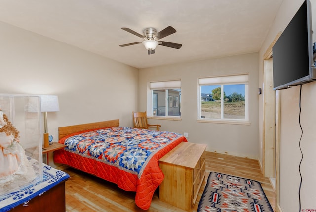 bedroom featuring light wood-style flooring and ceiling fan